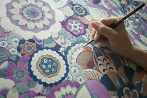 The Japanese artist Keiko Yanagisawa at work, creating her intricate floral designs.