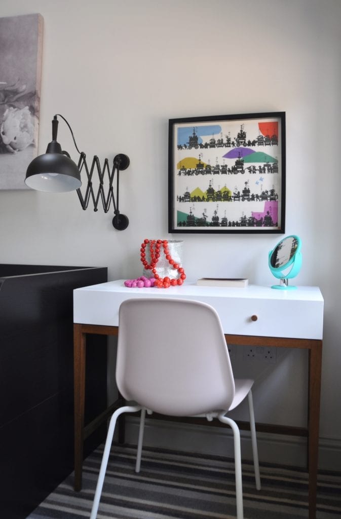 Colourful, Japanese framed wall art above a desk in a modern bedroom.