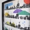 A colourful, Japanese silkscreen print depicting the Gion festival in a simple, black frame.