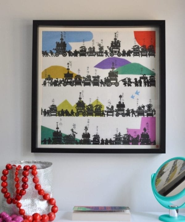 A colourful framed Japanese silkscreen above a dressing table.