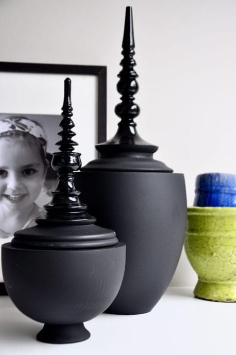 Matt and gloss black Thai decorative lidded pots in two sizes.