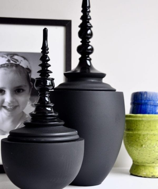 Matt and gloss black Thai decorative lidded pots in two sizes.