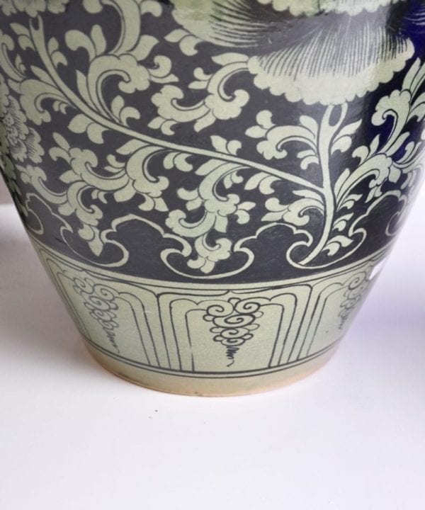 Typically Thai motifs adorn a hand-painted celadon pot from northern Thailand.