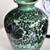 Asian pottery pot in green with hand-painted Lotus flower decoration.