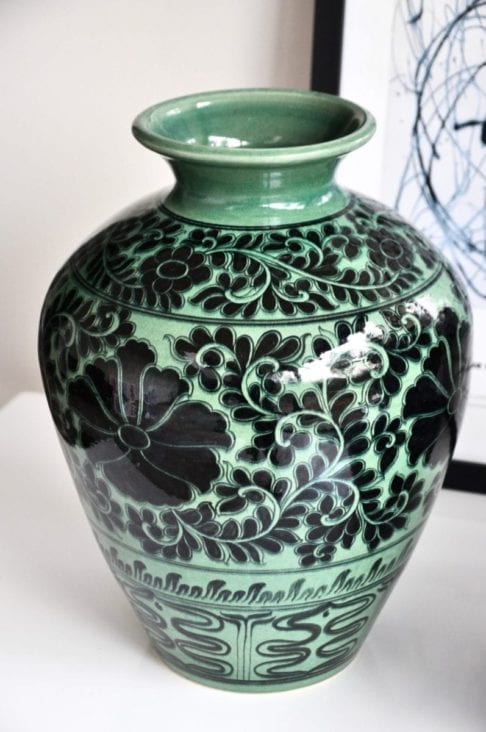 Asian pottery pot in green with hand-painted Lotus flower decoration.