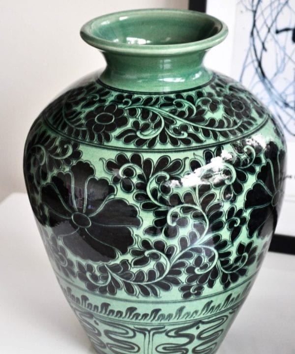 Asian pottery pot in green with hand-painted Lotus flower decoration.