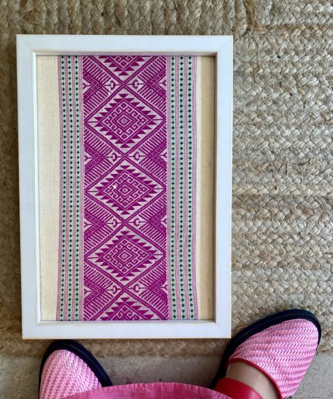 Pink wall art created from a handloom Thai textile.