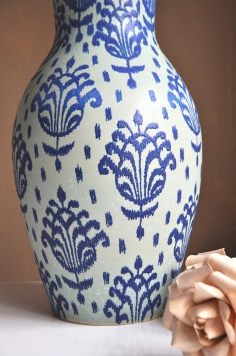 Typically Thai motifs, hand-painted onto a tall, decorative pot from a pottery in northern Thailand.