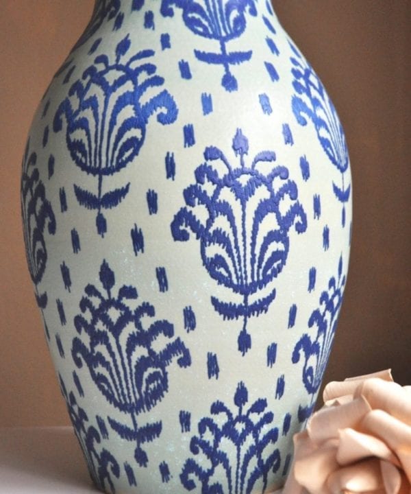 Typically Thai motifs, hand-painted onto a tall, decorative pot from a pottery in northern Thailand.