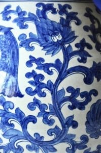 Detail of a handmade, Thai large blue and white pot with swimming fish and lotus designs.