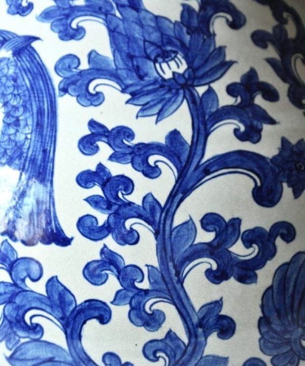 Detail of a handmade, Thai large blue and white pot with swimming fish and lotus designs.