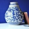 A large blue and white pot with typically Thai swimming fish and lotus flower motifs.