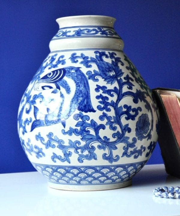 A large blue and white pot with typically Thai swimming fish and lotus flower motifs.