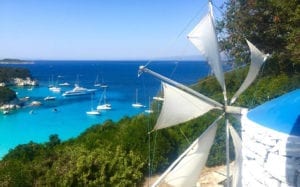 A view from a clifftop restaurant overlooking a beach on Antipaxos in Greece.