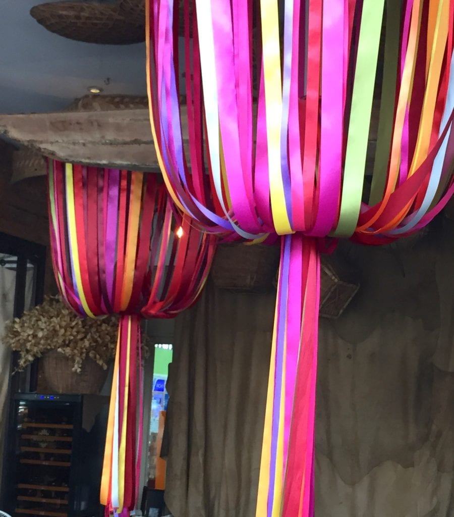 Diaphanous pink and yellow ribbon sculptures used to decorate the ceiling of a bar on the Bangkok riverside.