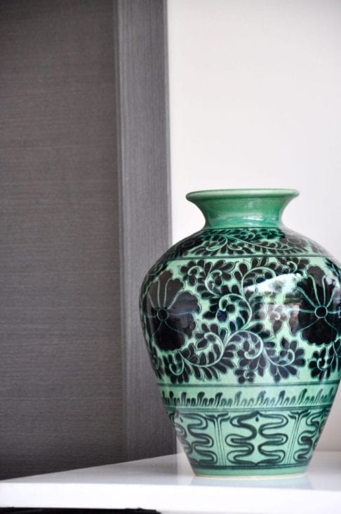 A hand-decorated, Lotus patterned pot in green and black from a Thai pottery in Chiangmai.