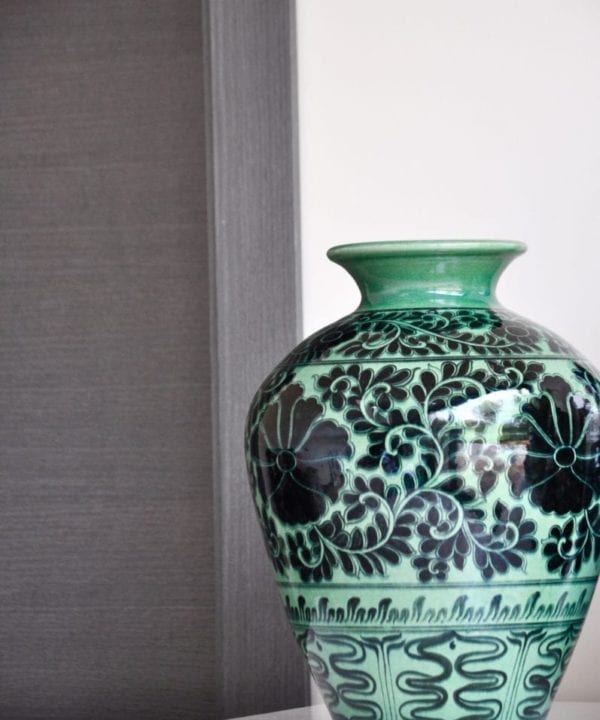 A hand-decorated, Lotus patterned pot in green and black from a Thai pottery in Chiangmai.