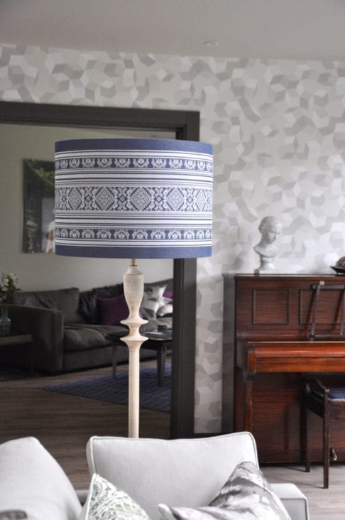 A large blue and white lampshade with a Folk style design inspired by traditional Hungarian costume.