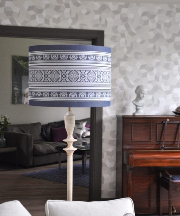 A large blue and white lampshade with a Folk style design inspired by traditional Hungarian costume.