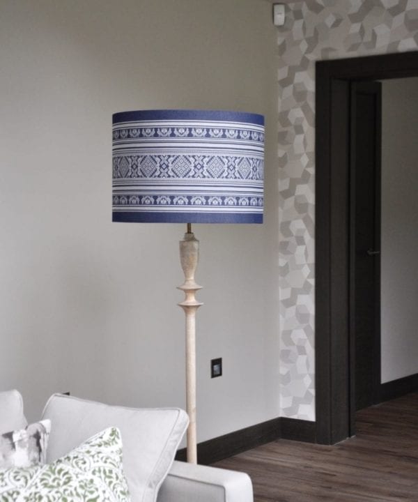 A blue shade provides a decorative accent in this neutral space while charcoal grey skirtings and architraves frame each space.