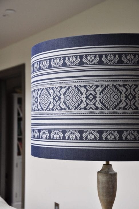 A large, drum shade suitable for a floor lamp handmade using a Hungarian Folk-inspired weave in blue and white.