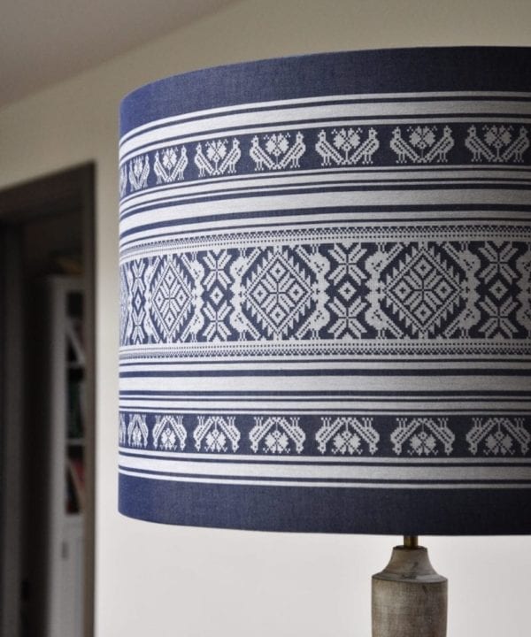 A large, drum shade suitable for a floor lamp handmade using a Hungarian Folk-inspired weave in blue and white.