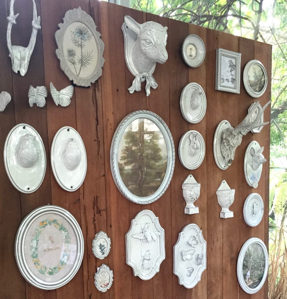 Various wall-décor items such as mirrors, plaques and busts in glazed white ceramic displayed at the Yarnnakarn ceramics studio in Bangkok, Thailand.