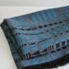 A blue and black fringed wrap scarf in the softest cashmere.