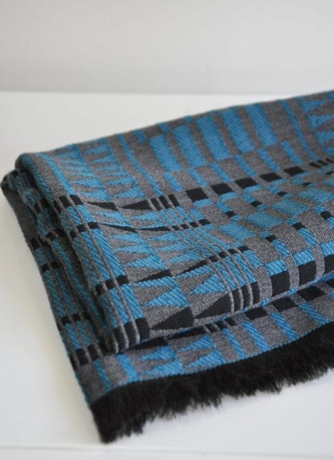 A blue and black fringed wrap scarf in the softest cashmere.