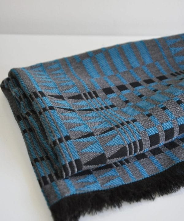 A blue and black fringed wrap scarf in the softest cashmere.