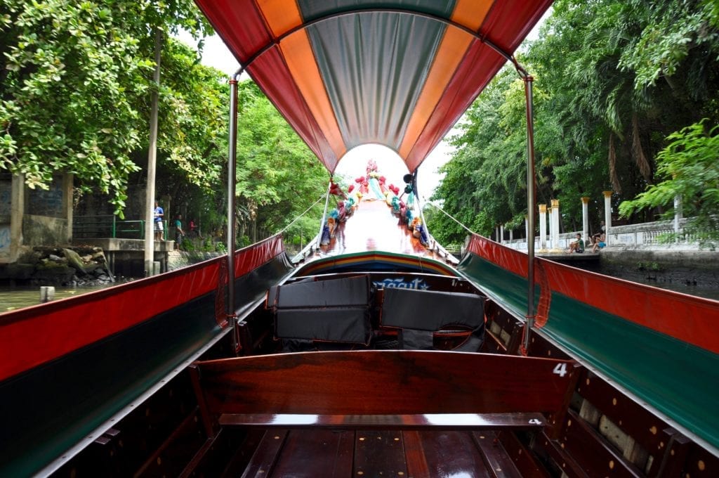 View from inside a Thai longtail boat travelling along the Chao Phraya river in Bangkok.