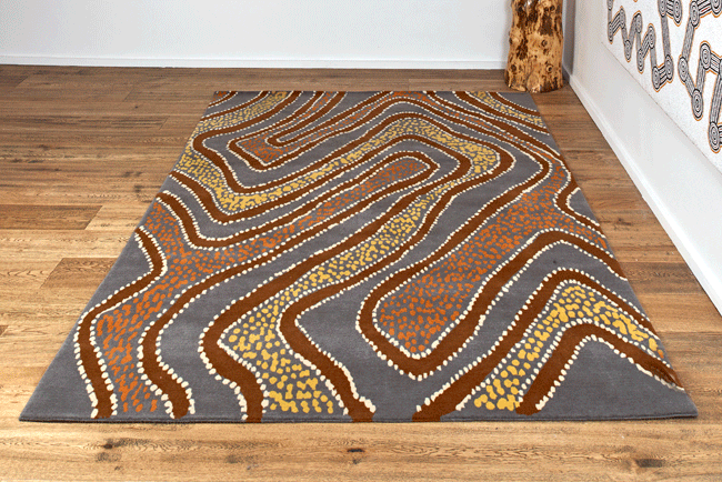 An Aboriginal art inspired rug in grey and brown.