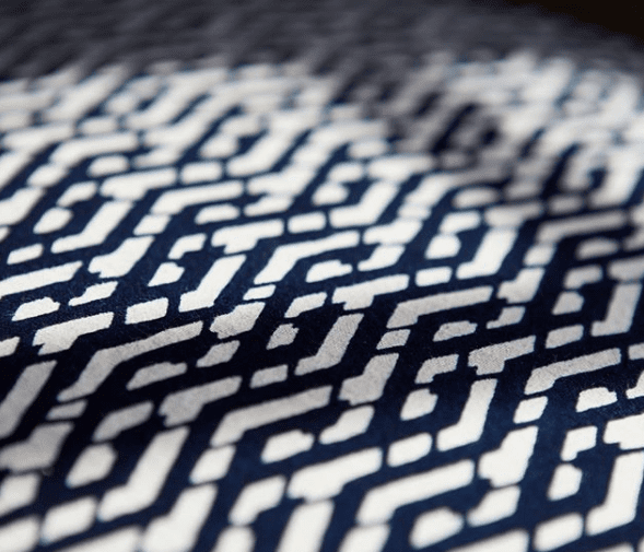 Detail of the indigo Eastern lattice print cushion fabric from Blue Handed through Telescope Style.