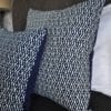 Indigo cushions with Eastern styling dressing a bed.