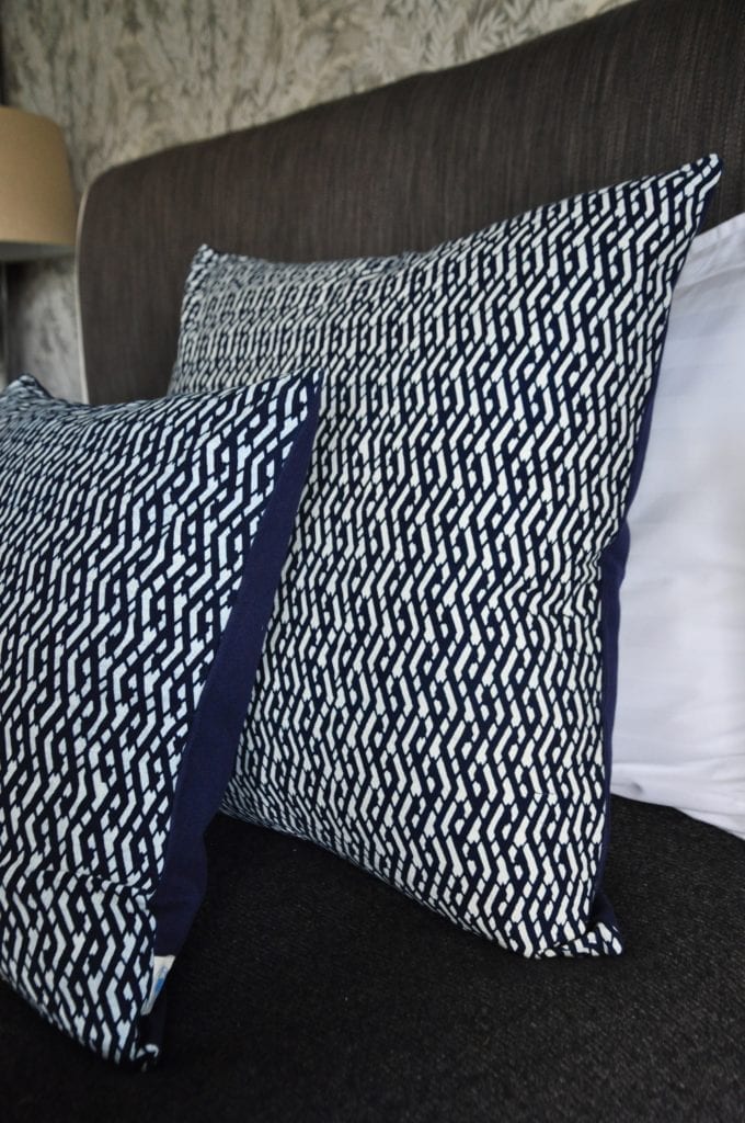 Indigo cushions with Eastern styling dressing a bed.