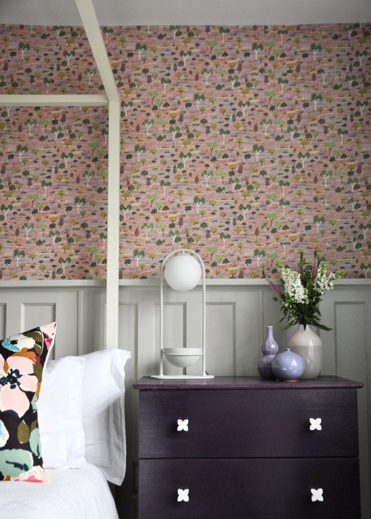 Pink trees and botanicals Aboriginal pastel wallpaper in a bedroom.