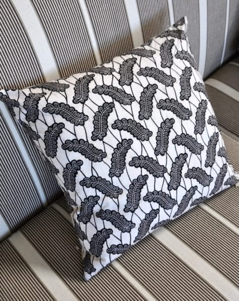 A black and white, 45cm x 45cm cushion in African Dutch wax print, available through Telescope Style.