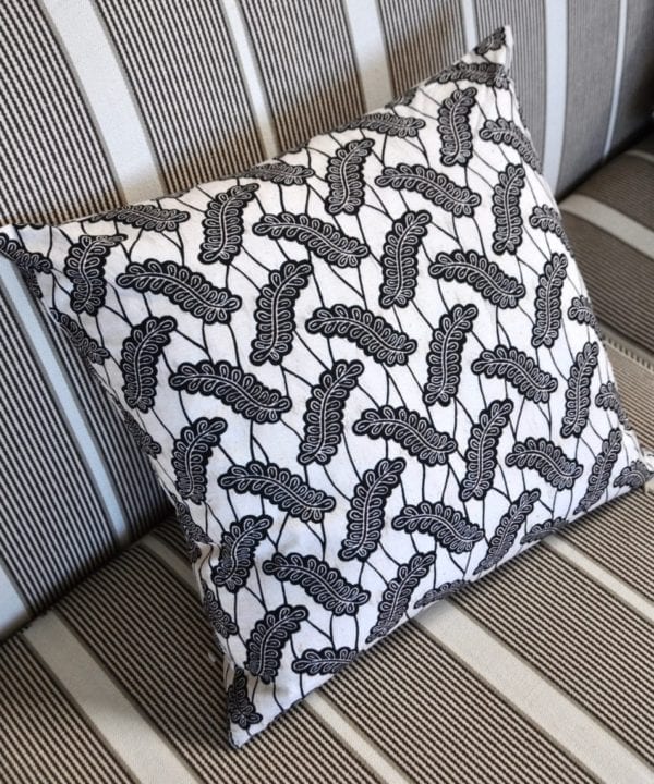 A black and white, 45cm x 45cm cushion in African Dutch wax print, available through Telescope Style.