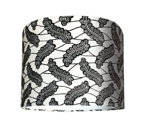 A cut-out shot of a small, monochrome lampshade in African Dutch wax print.