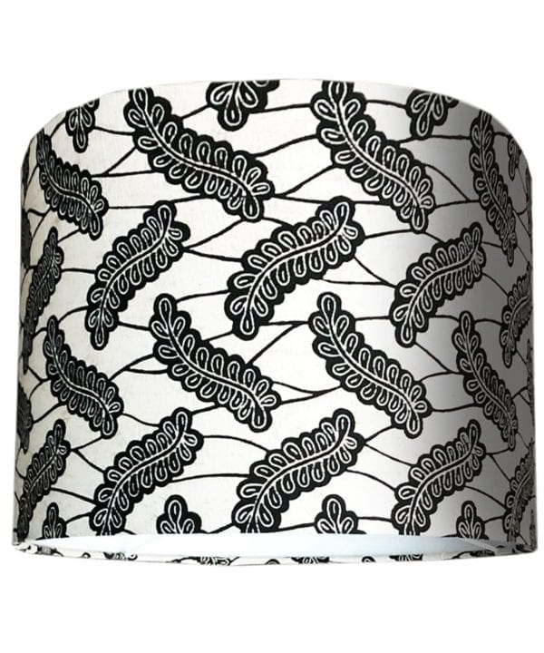 A cut-out shot of a small, monochrome lampshade in African Dutch wax print.