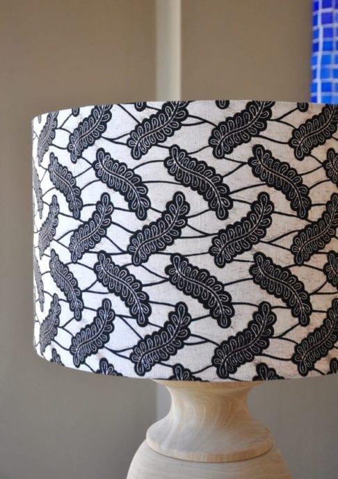 A Dutch wax print botanical fabric in monochrome on a large drum lampshade, available through Telescope Style.