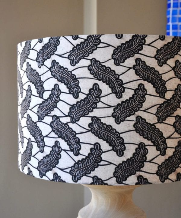 A Dutch wax print botanical fabric in monochrome on a large drum lampshade, available through Telescope Style.