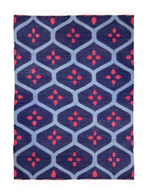 A blue and red rug with a trellis pattern.