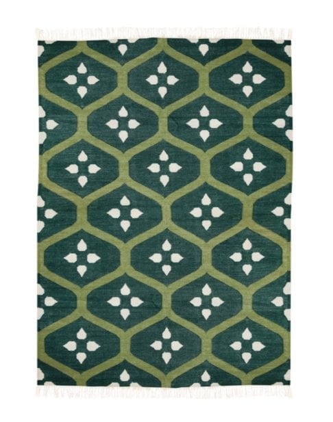 A green trellis rug handmade in India. The flatweave is in a lawn green colourway.