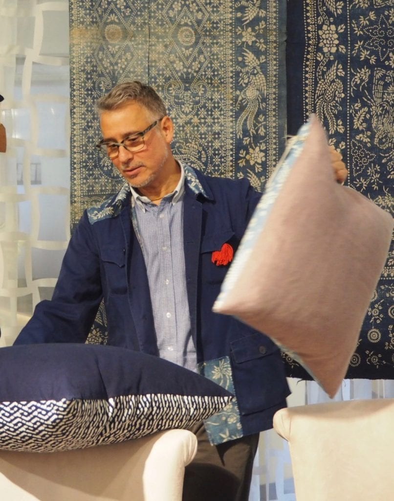 John Abbate displaying his elegant range of hand-made indigo print cushions.