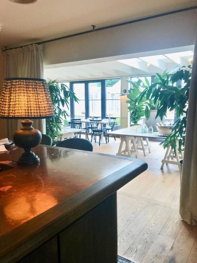 A view from the bar looking towards the dining conservatory at The Gallivant; a hotel and restaurant in Camber Sands near Rye in Sussex.