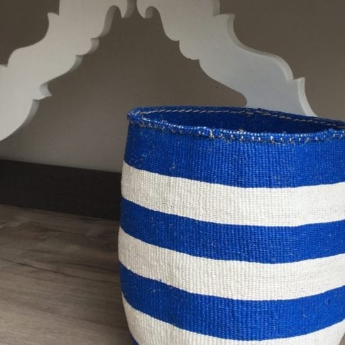 Close-up shot of a hand-woven, Royal blue and white striped basket.