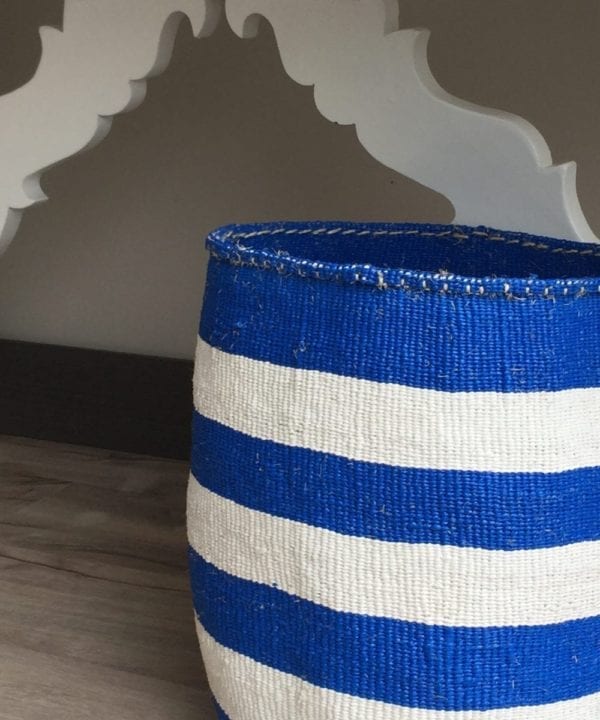 Close-up shot of a hand-woven, Royal blue and white striped basket.