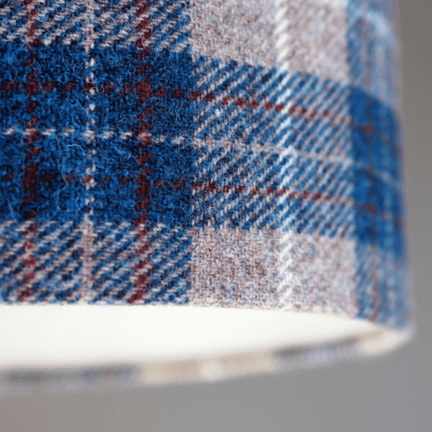 Detail of a blue check Harris tweed lampshade.