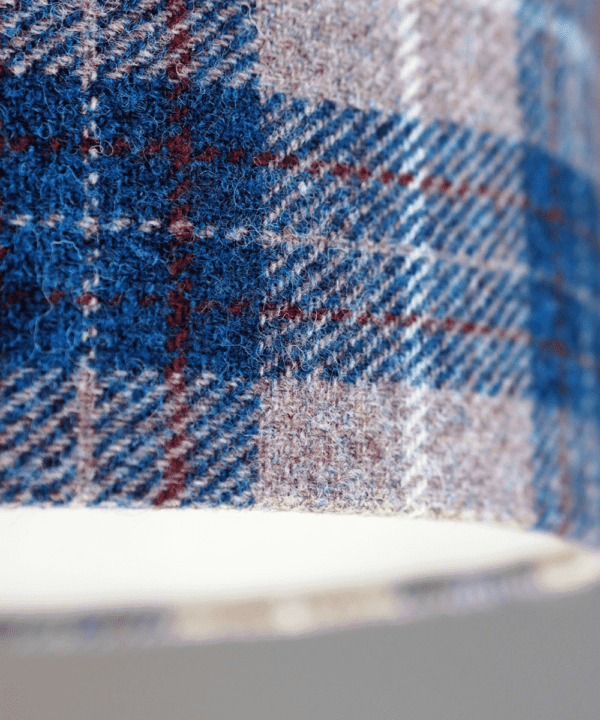 Detail of a blue check Harris tweed lampshade.